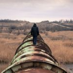 above-ground-pipeline-man-walking-inroads