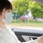 Masked Asian woman driver Getty